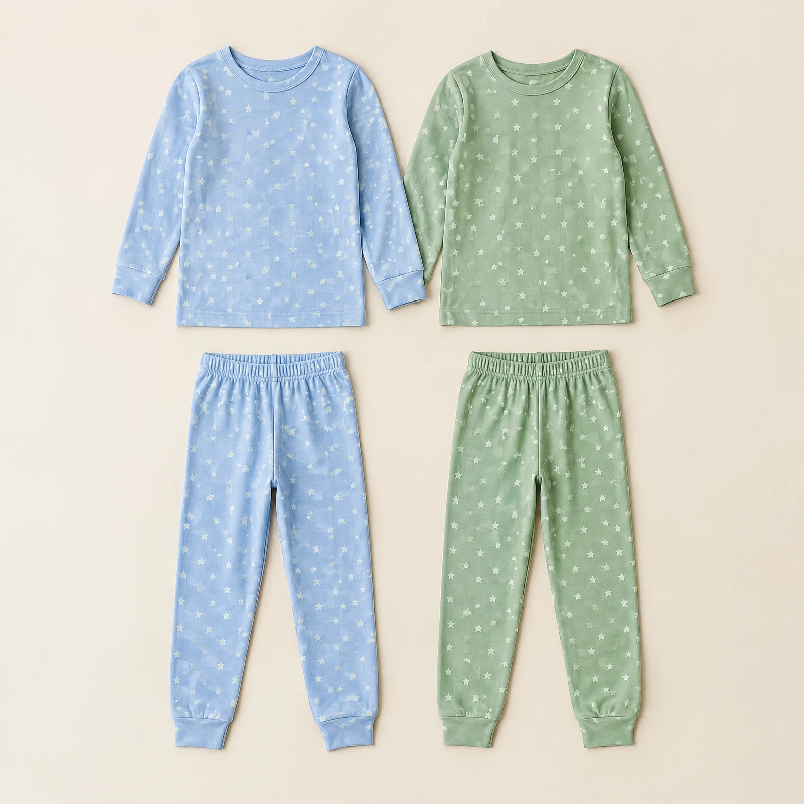 Light blue and sage green star-print kids' long-sleeve pajama tops with two matching pants laid flat