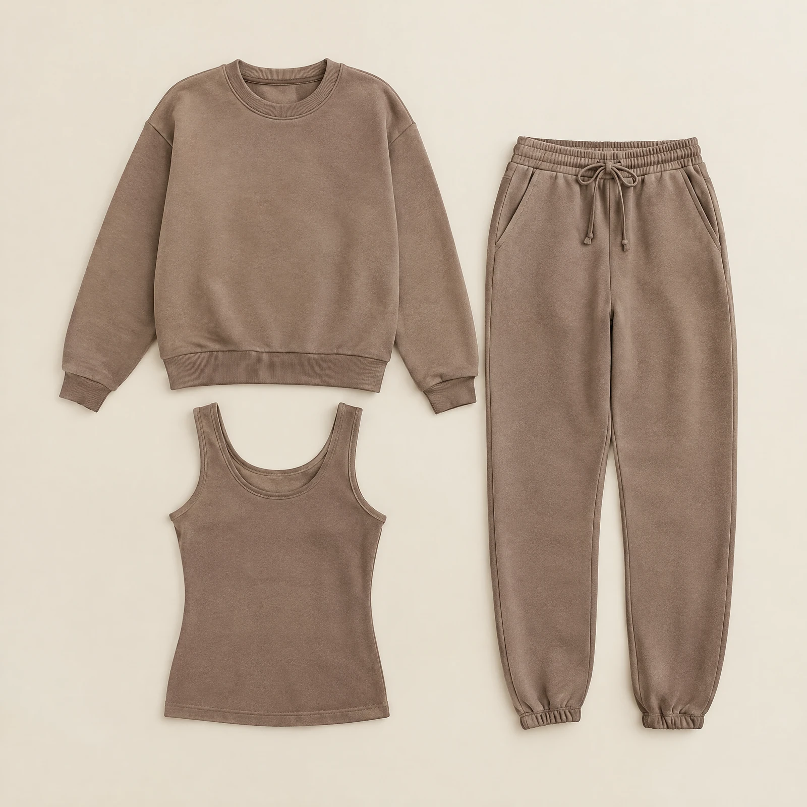 Warm taupe women's crewneck sweatshirt, jogger pants and tank top laid flat